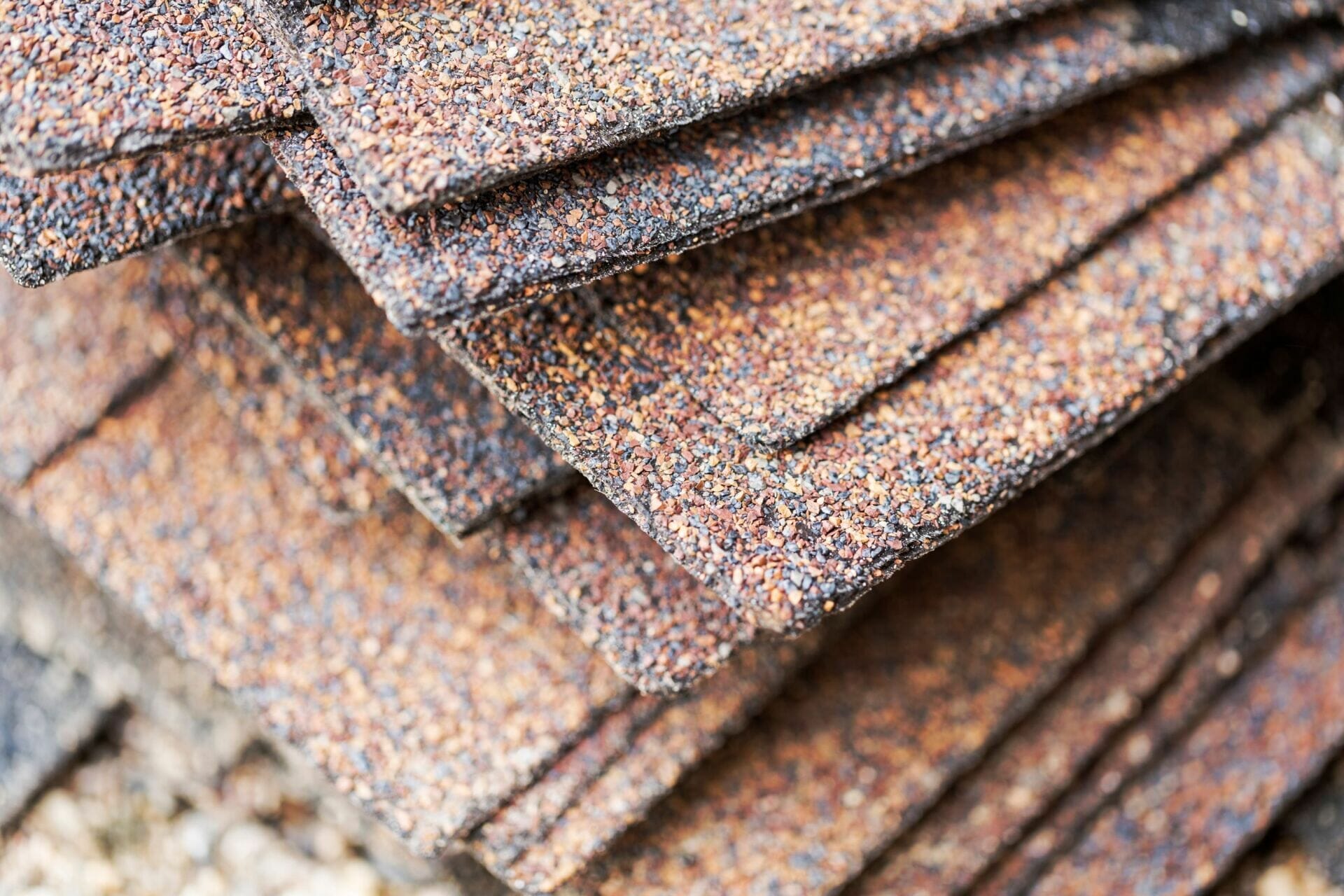 Stacked asphalt roofing shingles close-up