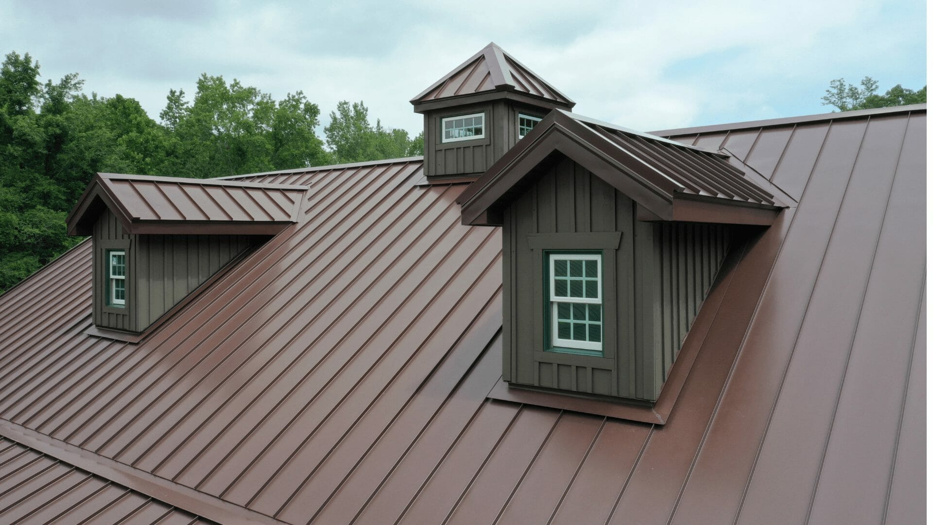 Brown metal roof with dormers and cupola